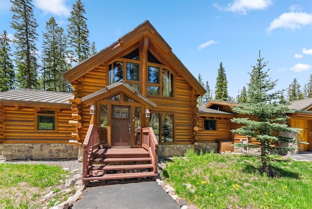 665 Whispering Pines Ln, Breckenridge, CO 80424 - cabin with log exterior, a standing seam roof, and a metal roof