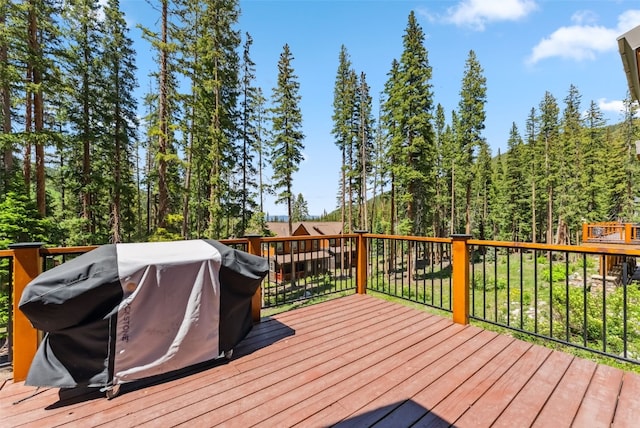 665 Whispering Pines Ln, Breckenridge, CO 80424 - deck with grilling area and a wooded view