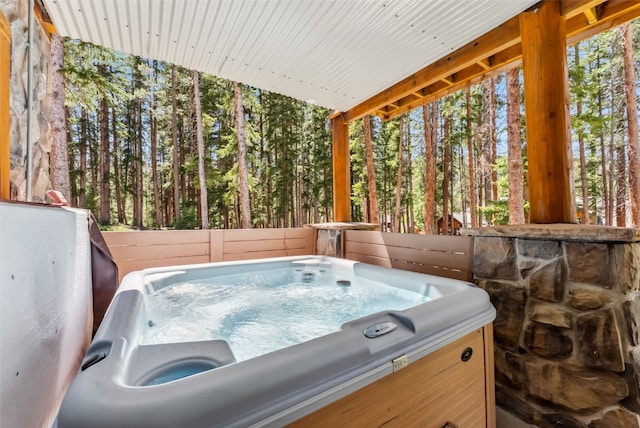 665 Whispering Pines Ln, Breckenridge, CO 80424 - view of patio featuring a hot tub and a wooded view