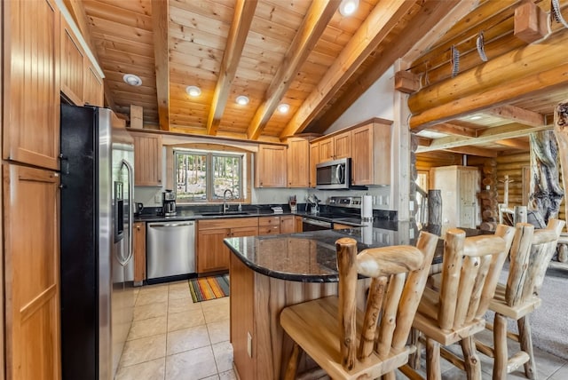 665 Whispering Pines Ln, Breckenridge, CO 80424 - kitchen with stainless steel appliances, a peninsula, light tile patterned floors, a kitchen bar, and wooden ceiling