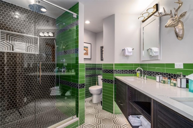 1875 Ski Time Square Dr Unit 711, Steamboat Springs, CO 80487 - bathroom with a sink, double vanity, toilet, tile walls, and a shower stall
