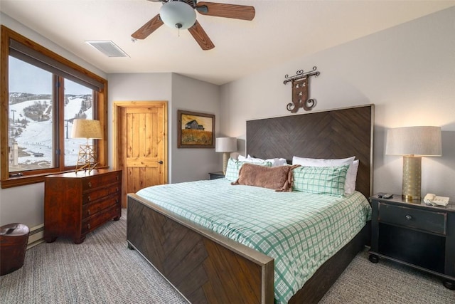 1875 Ski Time Square Dr Unit 711, Steamboat Springs, CO 80487 - carpeted bedroom featuring a baseboard heating unit, ceiling fan, and visible vents