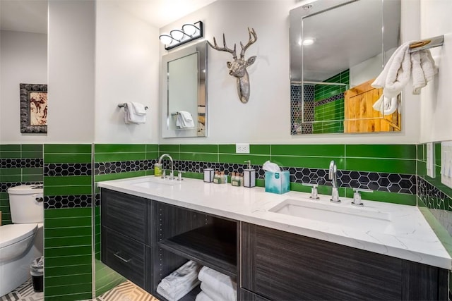 1875 Ski Time Square Dr Unit 711, Steamboat Springs, CO 80487 - full bathroom featuring toilet, a sink, double vanity, and tile walls