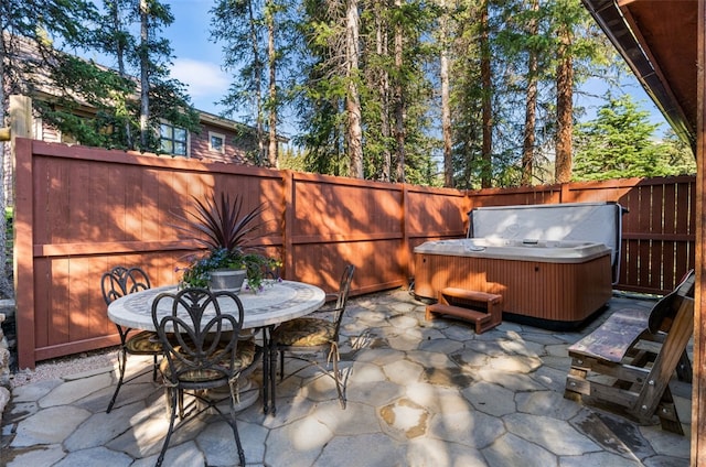 654 County Road 672, Breckenridge, CO 80424 - view of patio with a fenced backyard, a hot tub, and outdoor dining space