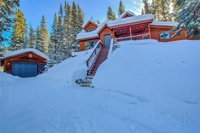 654 County Road 672, Breckenridge, CO 80424 - view of front facade with a garage, a porch, stairway, and log veneer siding