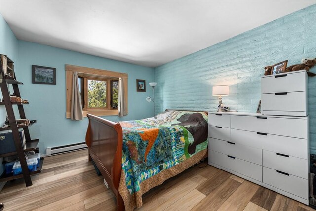 21 Balsam Ct, Steamboat Springs, CO 80487 - bedroom featuring a baseboard heating unit and light wood-style floors