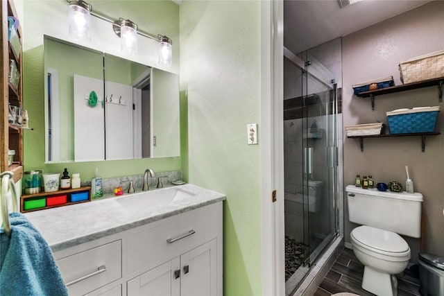 21 Balsam Ct, Steamboat Springs, CO 80487 - bathroom featuring a textured wall, vanity, a shower stall, and toilet