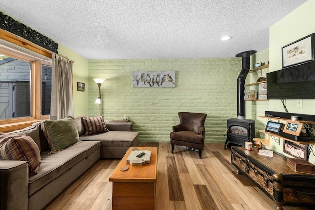 21 Balsam Ct, Steamboat Springs, CO 80487 - living room featuring a textured ceiling, a wood stove, and brick wall