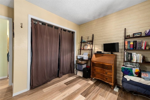 21 Balsam Ct, Steamboat Springs, CO 80487 - bedroom with baseboards, wood finished floors, a textured ceiling, and a closet