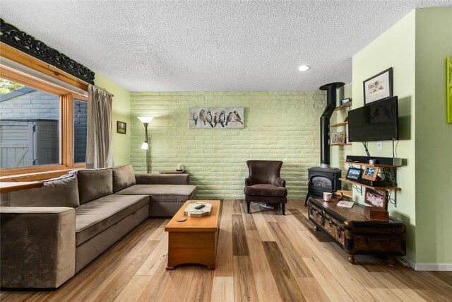 21 Balsam Ct, Steamboat Springs, CO 80487 - living room with brick wall, wood finished floors, a textured ceiling, and a wood stove
