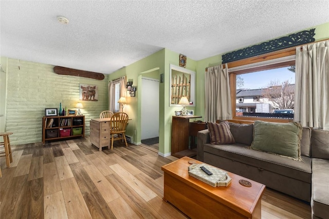 21 Balsam Ct, Steamboat Springs, CO 80487 - living room featuring baseboards, wood finished floors, and a textured ceiling