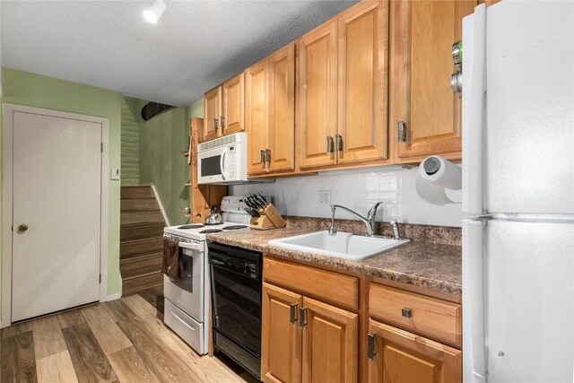 21 Balsam Ct, Steamboat Springs, CO 80487 - kitchen featuring light wood-style flooring, white appliances, and a sink