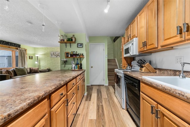 21 Balsam Ct, Steamboat Springs, CO 80487 - kitchen with a textured ceiling, light wood finished floors, a sink, and white appliances