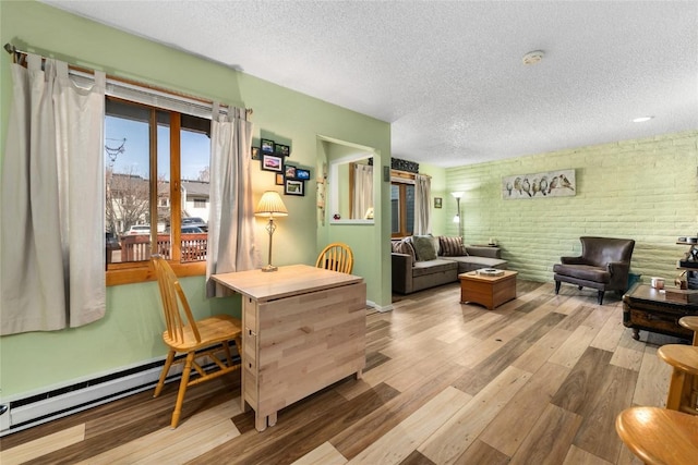 21 Balsam Ct, Steamboat Springs, CO 80487 - living area with brick wall, wood finished floors, and a textured ceiling