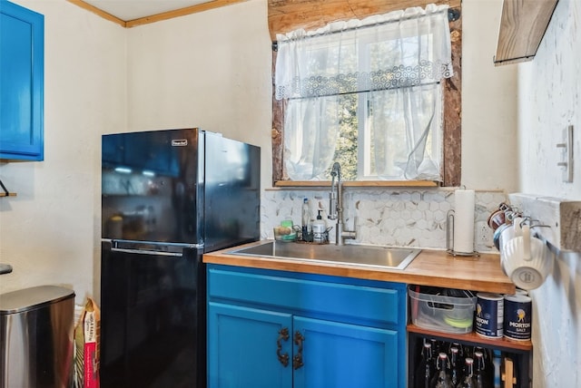 50 Puma Ct, Como, CO 80432 - kitchen with blue cabinetry, tasteful backsplash, a sink, and freestanding refrigerator