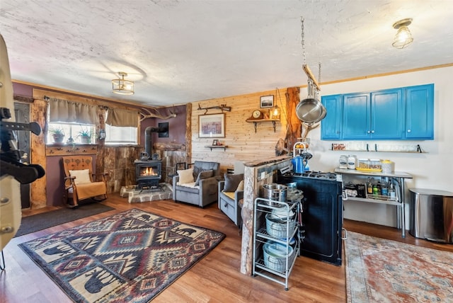 50 Puma Ct, Como, CO 80432 - living room featuring wooden walls, wood finished floors, and a wood stove