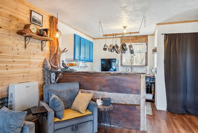 50 Puma Ct, Como, CO 80432 - kitchen featuring blue cabinets, wood finished floors, crown molding, wooden walls, and refrigerator