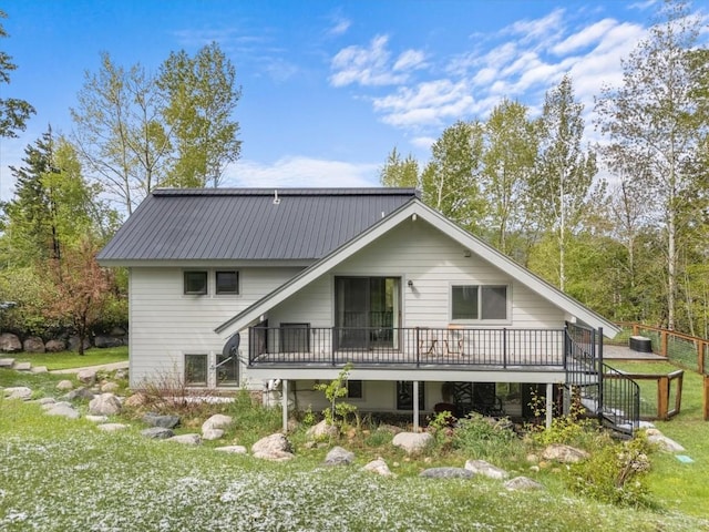 1750 Fish Creek Falls Rd, Steamboat Springs, CO 80487 - rear view of property featuring a wooden deck and metal roof