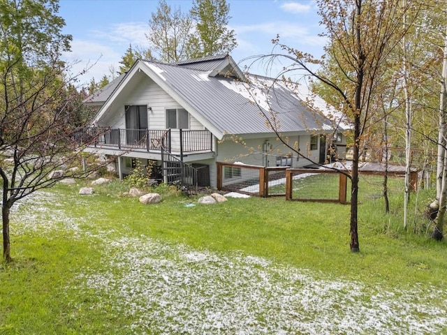 1750 Fish Creek Falls Rd, Steamboat Springs, CO 80487 - view of side of property featuring metal roof, a lawn, stairs, and a deck