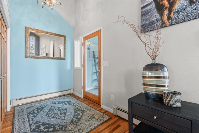 1750 Fish Creek Falls Rd, Steamboat Springs, CO 80487 - entryway featuring a baseboard radiator, wood finished floors, a chandelier, and baseboards