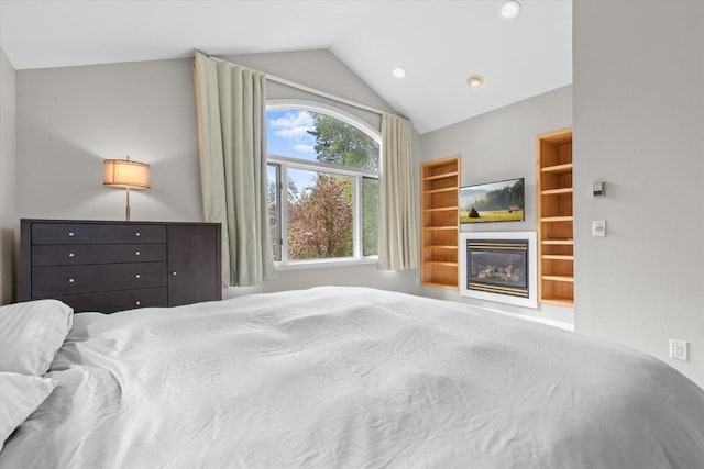 1750 Fish Creek Falls Rd, Steamboat Springs, CO 80487 - bedroom with vaulted ceiling, a glass covered fireplace, and recessed lighting