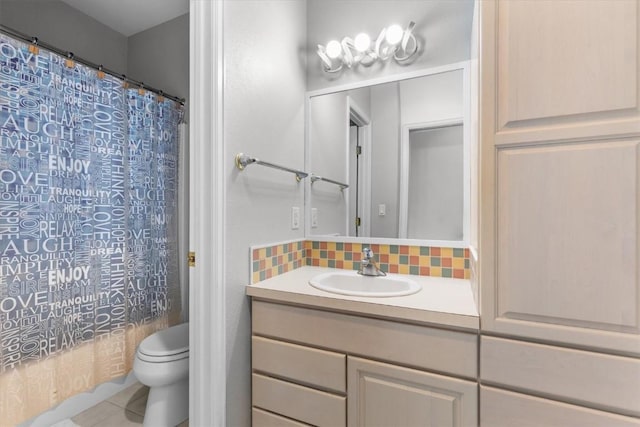 1750 Fish Creek Falls Rd, Steamboat Springs, CO 80487 - bathroom with vanity, toilet, shower / tub combo with curtain, decorative backsplash, and tile patterned flooring