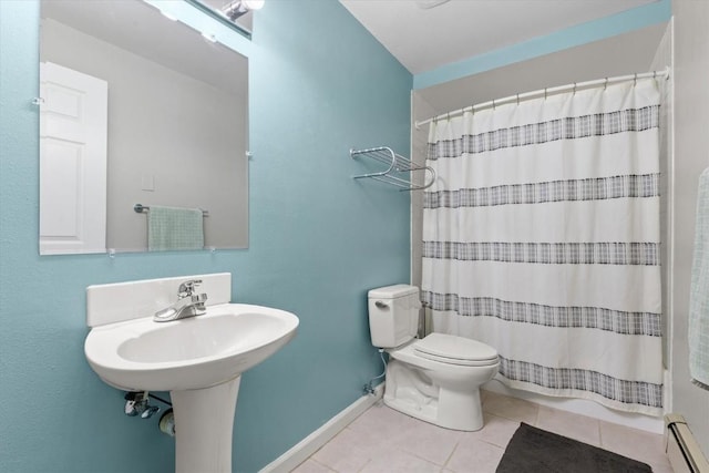 1750 Fish Creek Falls Rd, Steamboat Springs, CO 80487 - full bath with a baseboard heating unit, toilet, tile patterned flooring, and curtained shower
