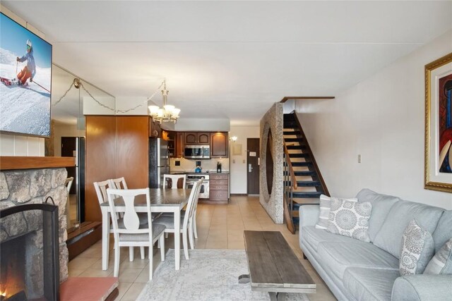 631 Village Rd Unit 36450, Breckenridge, CO 80424 - living room with a fireplace, a chandelier, stairway, and light tile patterned flooring