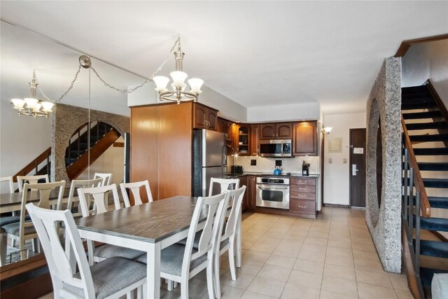 631 Village Rd Unit 36450, Breckenridge, CO 80424 - dining space featuring stairway, an inviting chandelier, and light tile patterned floors