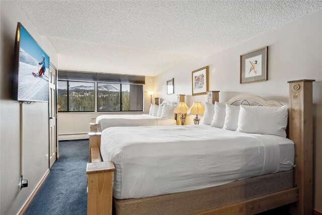 631 Village Rd Unit 36450, Breckenridge, CO 80424 - bedroom with dark colored carpet, a textured ceiling, and a baseboard radiator