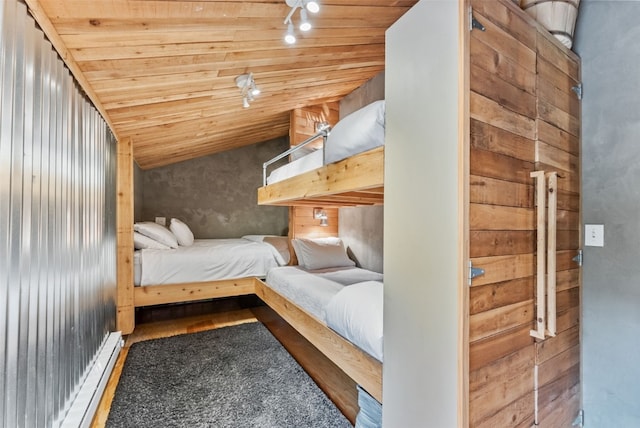 bedroom with wood ceiling, baseboard heating, wood finished floors, and lofted ceiling