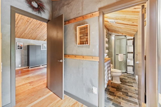 full bath with a stall shower, toilet, wood finished floors, and lofted ceiling