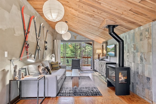living area featuring wood ceiling, a wood stove, wood finished floors, and lofted ceiling