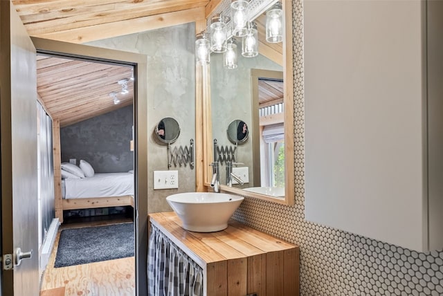 bathroom with vanity, connected bathroom, and vaulted ceiling