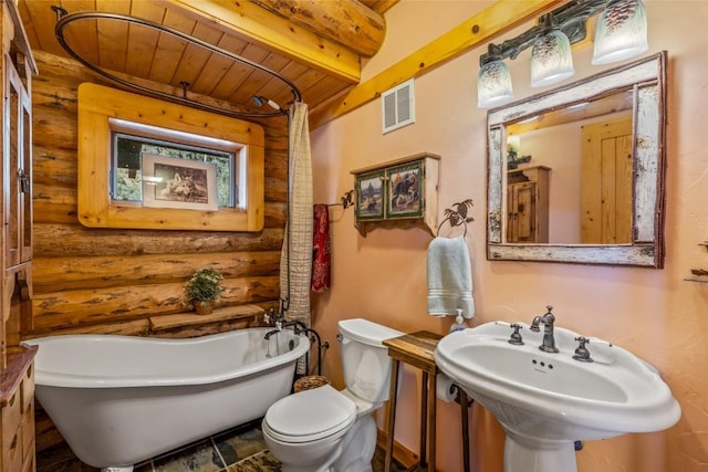 24110 Arapahoe Rd, Oak Creek, CO 80467 - bathroom with toilet, beam ceiling, visible vents, log walls, and a soaking tub