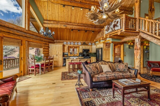 24110 Arapahoe Rd, Oak Creek, CO 80467 - living room with an inviting chandelier, high vaulted ceiling, and wooden ceiling