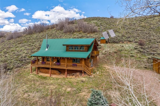 24110 Arapahoe Rd, Oak Creek, CO 80467 - rear view of property featuring a porch, log siding, and metal roof