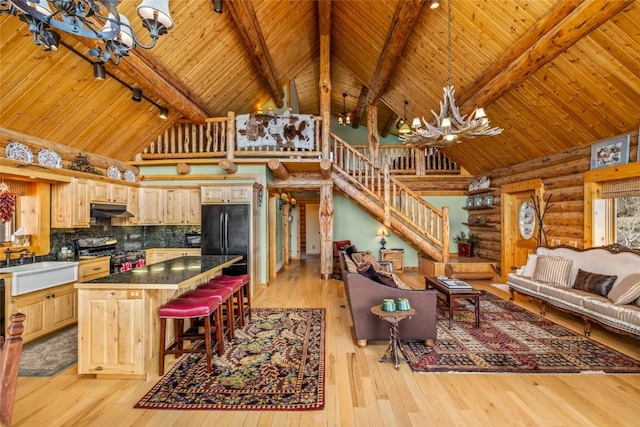 24110 Arapahoe Rd, Oak Creek, CO 80467 - living room with an inviting chandelier, wood ceiling, and log walls