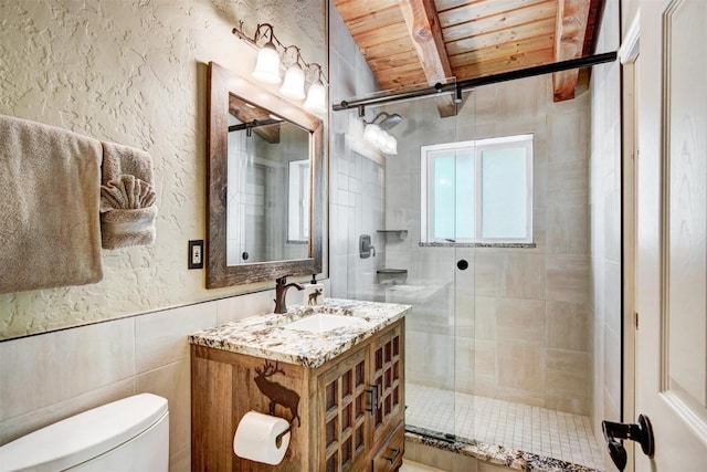 bathroom with a shower stall, toilet, vanity, wooden ceiling, and beam ceiling