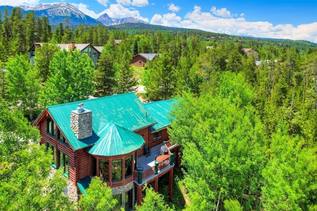 birds eye view of property with a view of trees and a mountain view