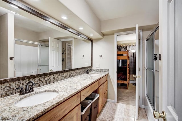 full bath featuring an enclosed shower, a sink, and a closet