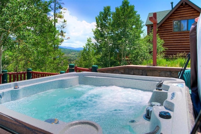 view of swimming pool featuring a hot tub