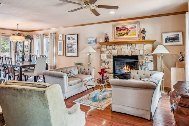 112 Grey Squirrel Ln, Breckenridge, CO 80424 - living room featuring crown molding, wood finished floors, a ceiling fan, recessed lighting, and a stone fireplace