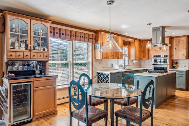 112 Grey Squirrel Ln, Breckenridge, CO 80424 - kitchen featuring island range hood, wine cooler, double oven, light wood-style floors, and a sink