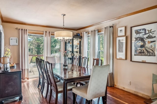112 Grey Squirrel Ln, Breckenridge, CO 80424 - dining area with wood-type flooring, ornamental molding, a chandelier, and baseboards