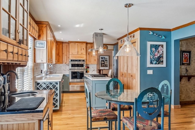 112 Grey Squirrel Ln, Breckenridge, CO 80424 - kitchen featuring island range hood, a sink, double oven, light wood-style flooring, and light countertops