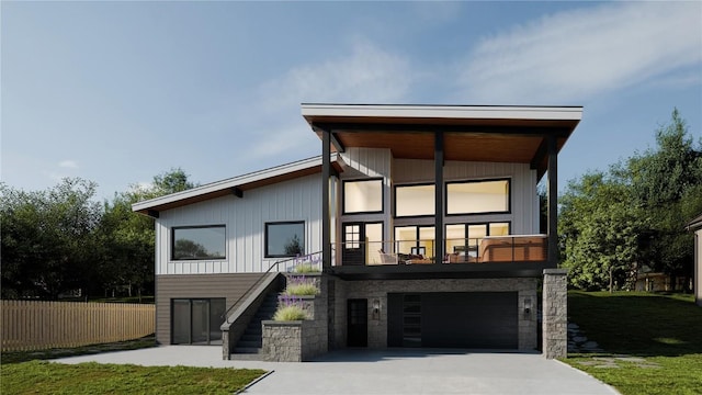 rear view of house with a garage and a lawn