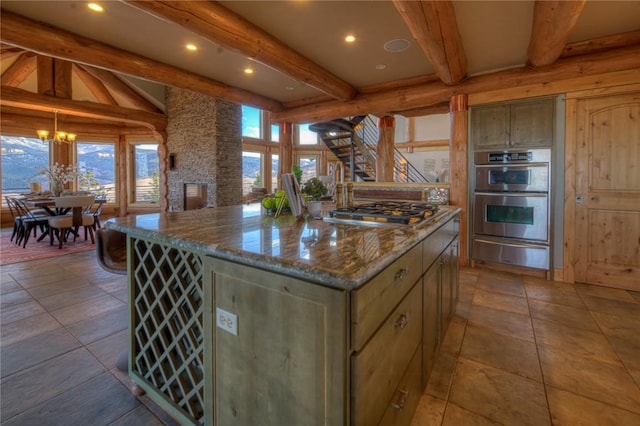 1390 Mountain Valley Rd, La Veta, CO 81055 - kitchen with a warming drawer, beam ceiling, appliances with stainless steel finishes, and a center island