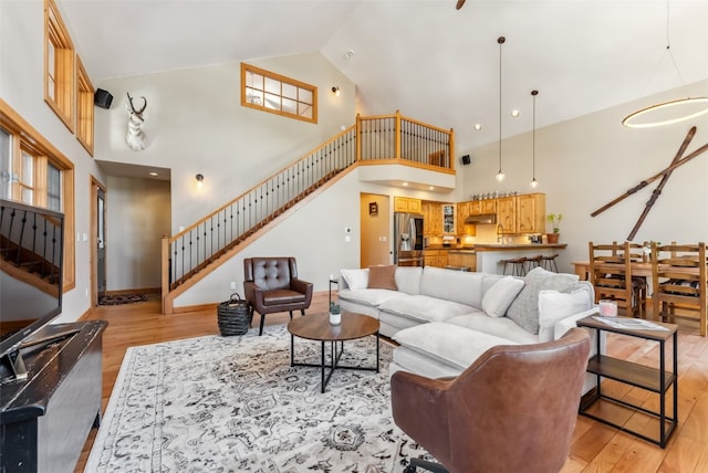 960 Whispering Pines Ln, Breckenridge, CO 80424 - living room featuring baseboards, stairs, light wood finished floors, and high vaulted ceiling