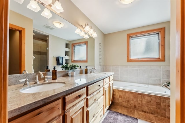 960 Whispering Pines Ln, Breckenridge, CO 80424 - bathroom with a tile shower, double vanity, visible vents, a sink, and a bath